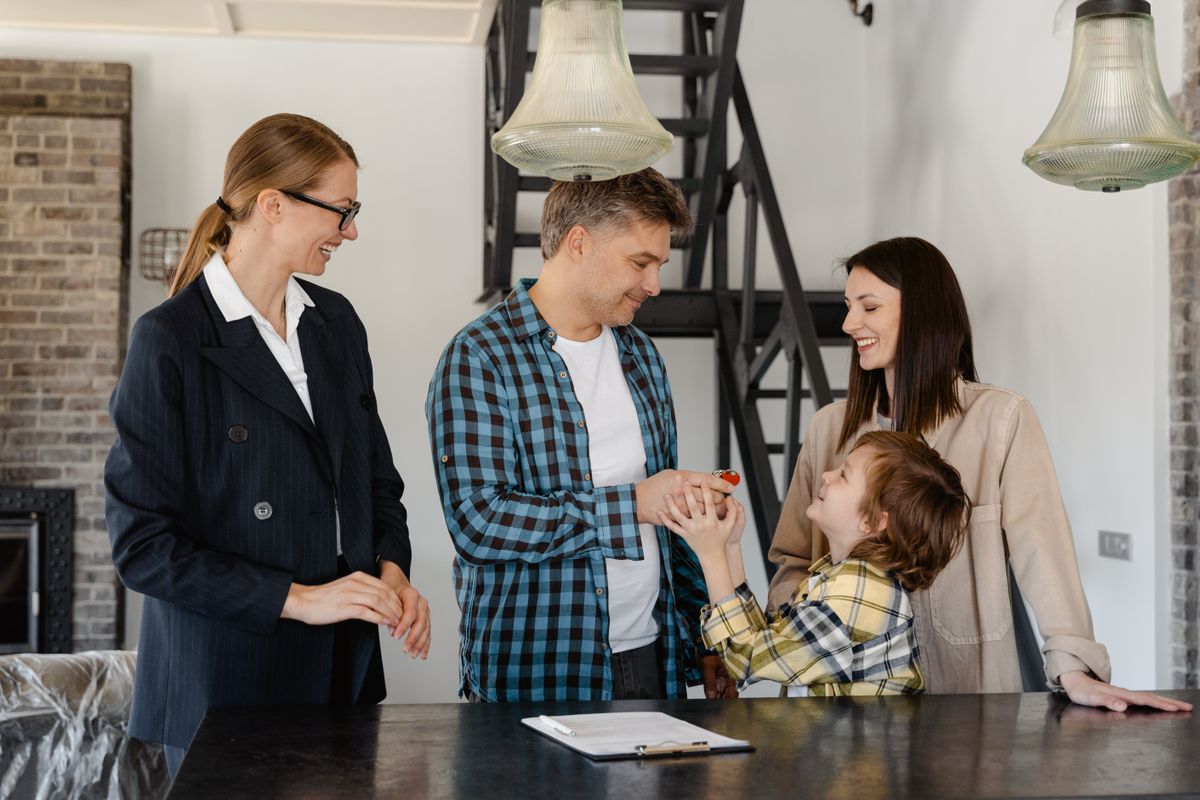 A family celebrating the keys to their new home