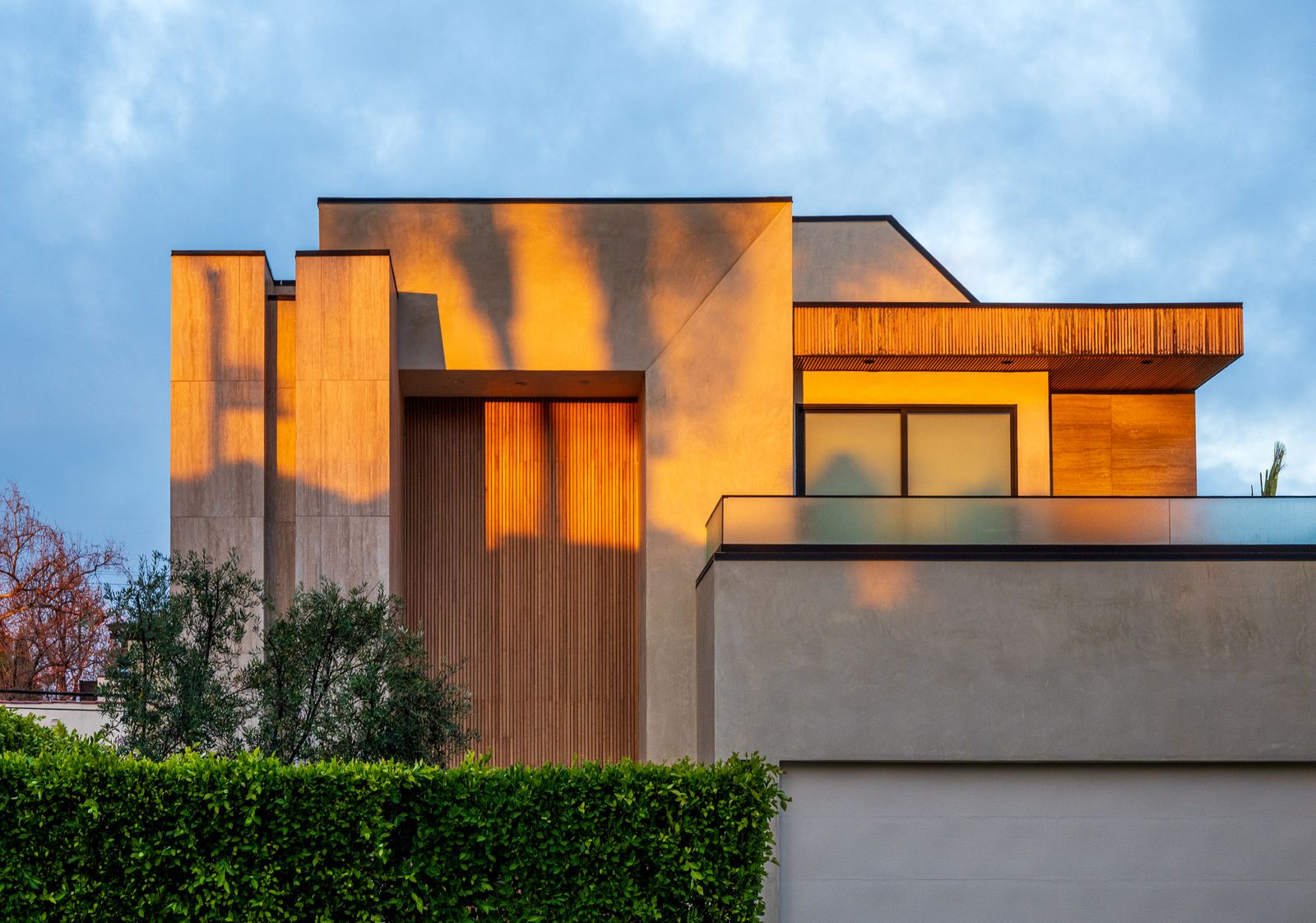 Modern California home glowing warm at sunset